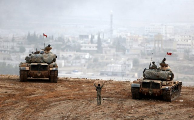 Turkish army tanks take position on top of a hill near Mursitpinar border crossing in the southeastern Turkish town of Suruc in Sanliurfa province, Turkey, October 11, 2014. REUTERS/Umit Bektas/File photo